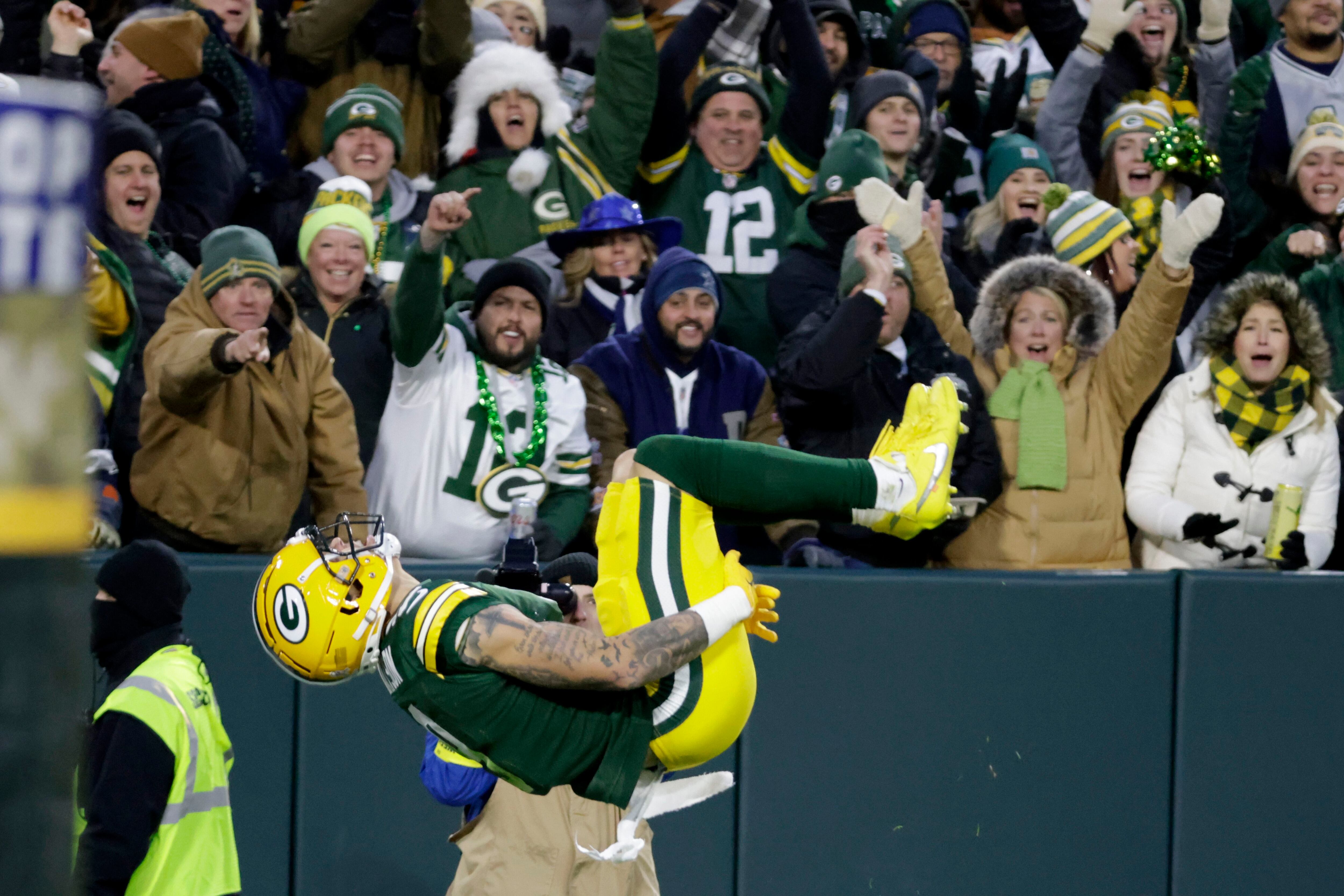 Dallas Cowboys' CeeDee Lamb (88), Dak Prescott (4) and Tony Pollard (20)  celebrate after Lamb scored a touchdown during the first half of an NFL  football game against the Green Bay Packers