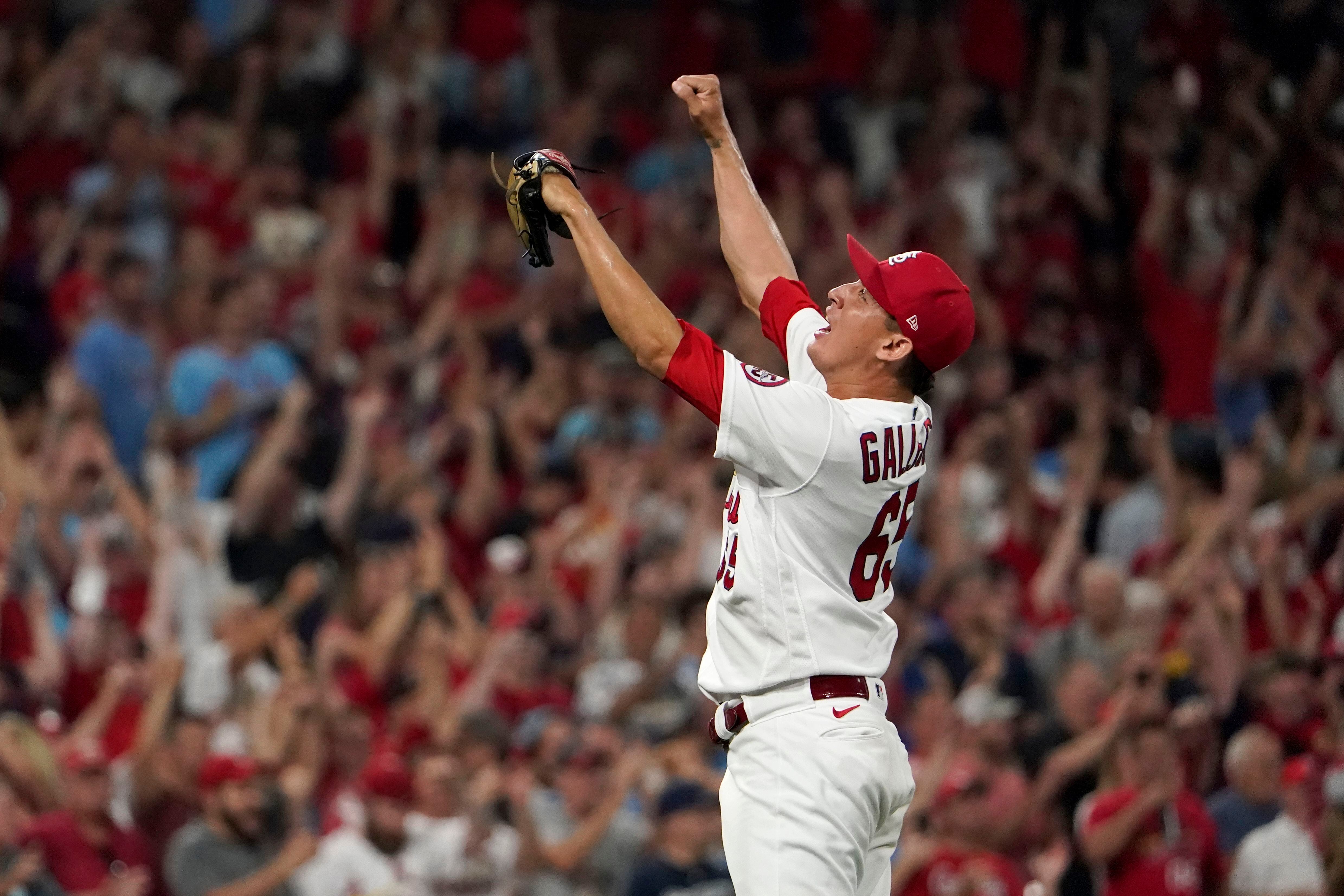 St. Louis Cardinals' Dylan Carlson is congratulated by teammates after  hitting a two-run home run during the fifth inning of the team's baseball  game against the Chicago Cubs on Tuesday, Aug. 2