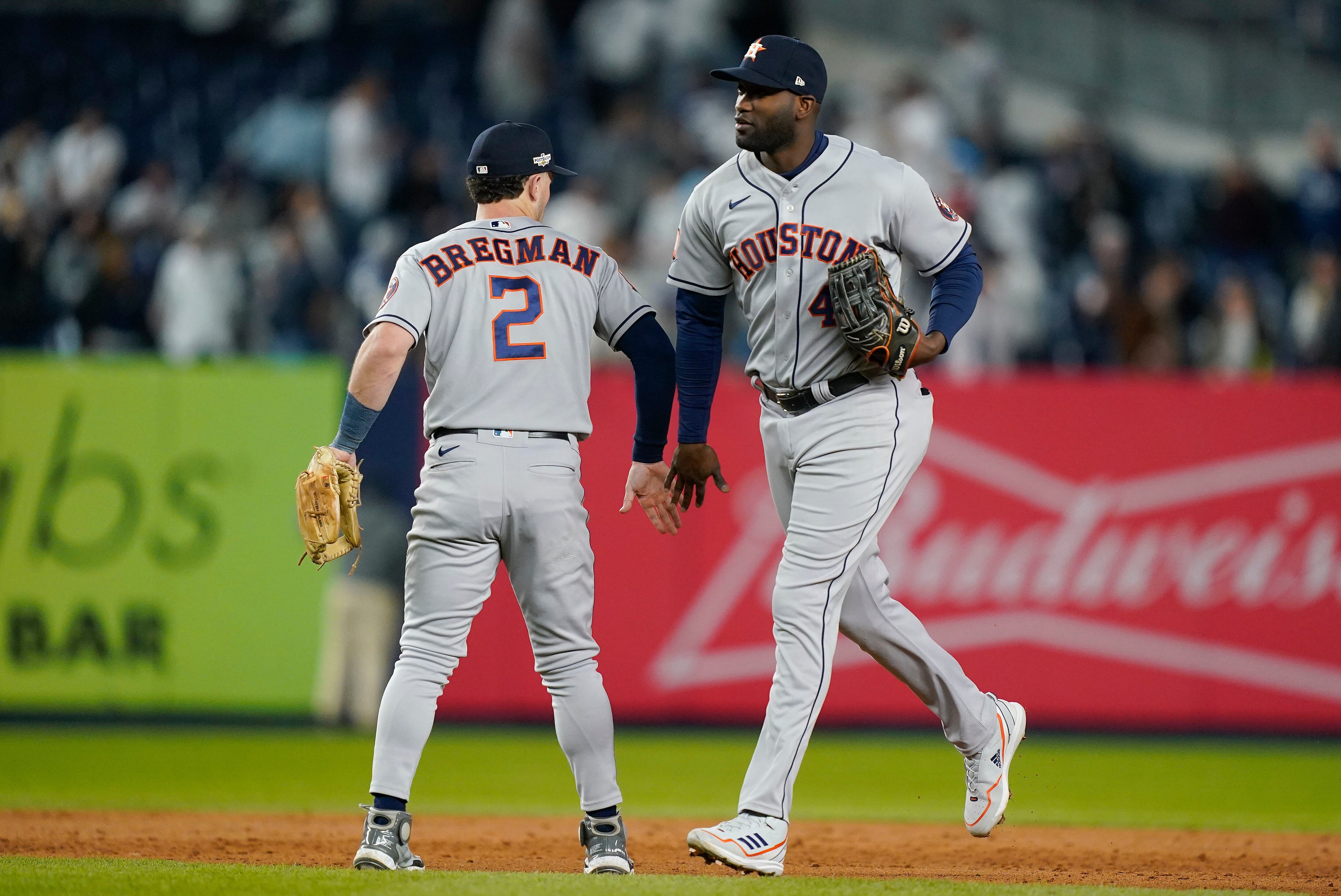 Houston Astros' Alex Bregman, left, points to a camera after hitting a home  run as catcher Christian Vazquez looks to the camera too during the eighth  inning of a baseball game against