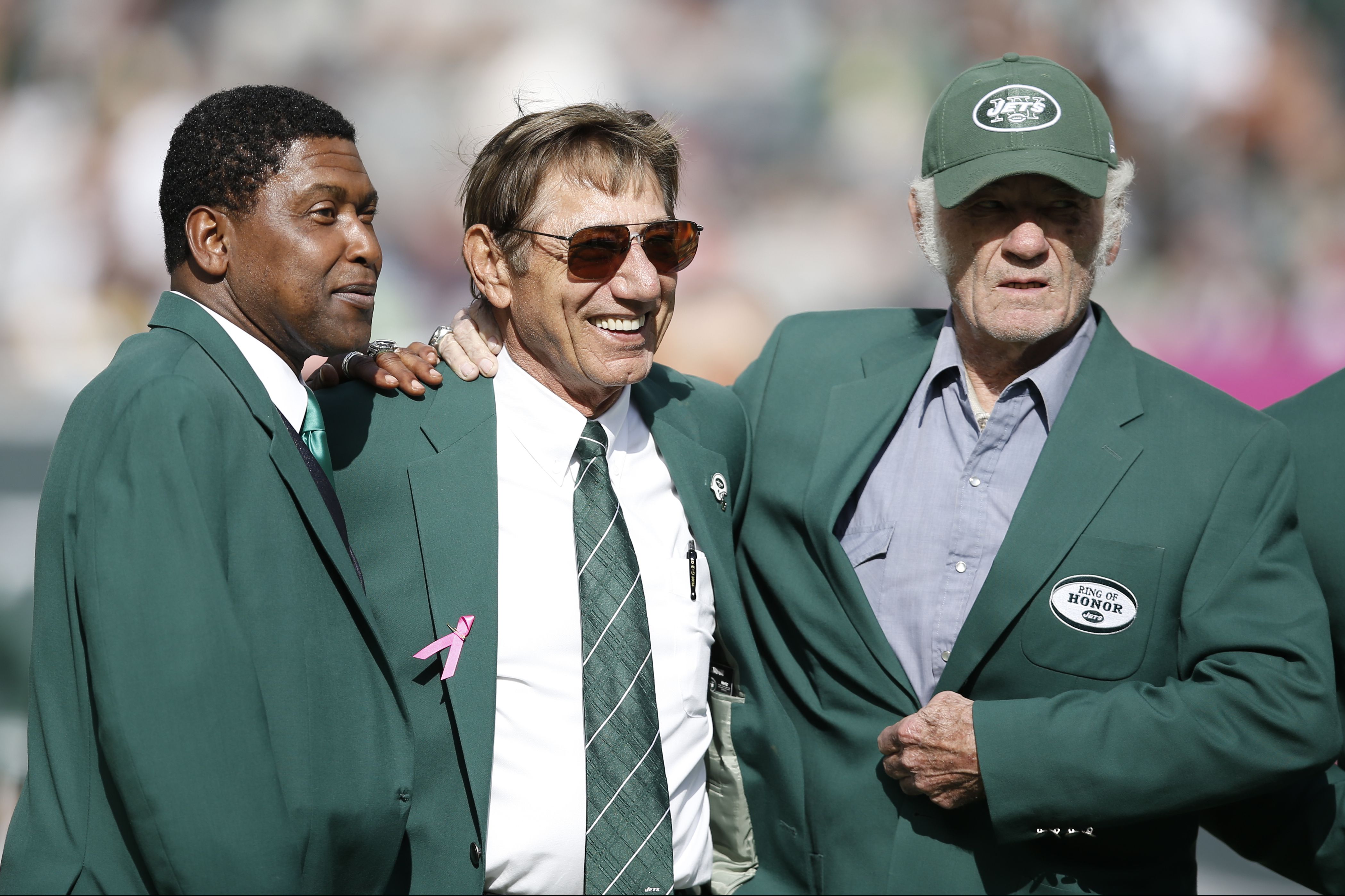 Don Maynard, left, and Joe Namath, center, joke with a member of Weeb  Ewbank's family during the Ring of Honor induction as the Jets faced  the New York Giants at the New