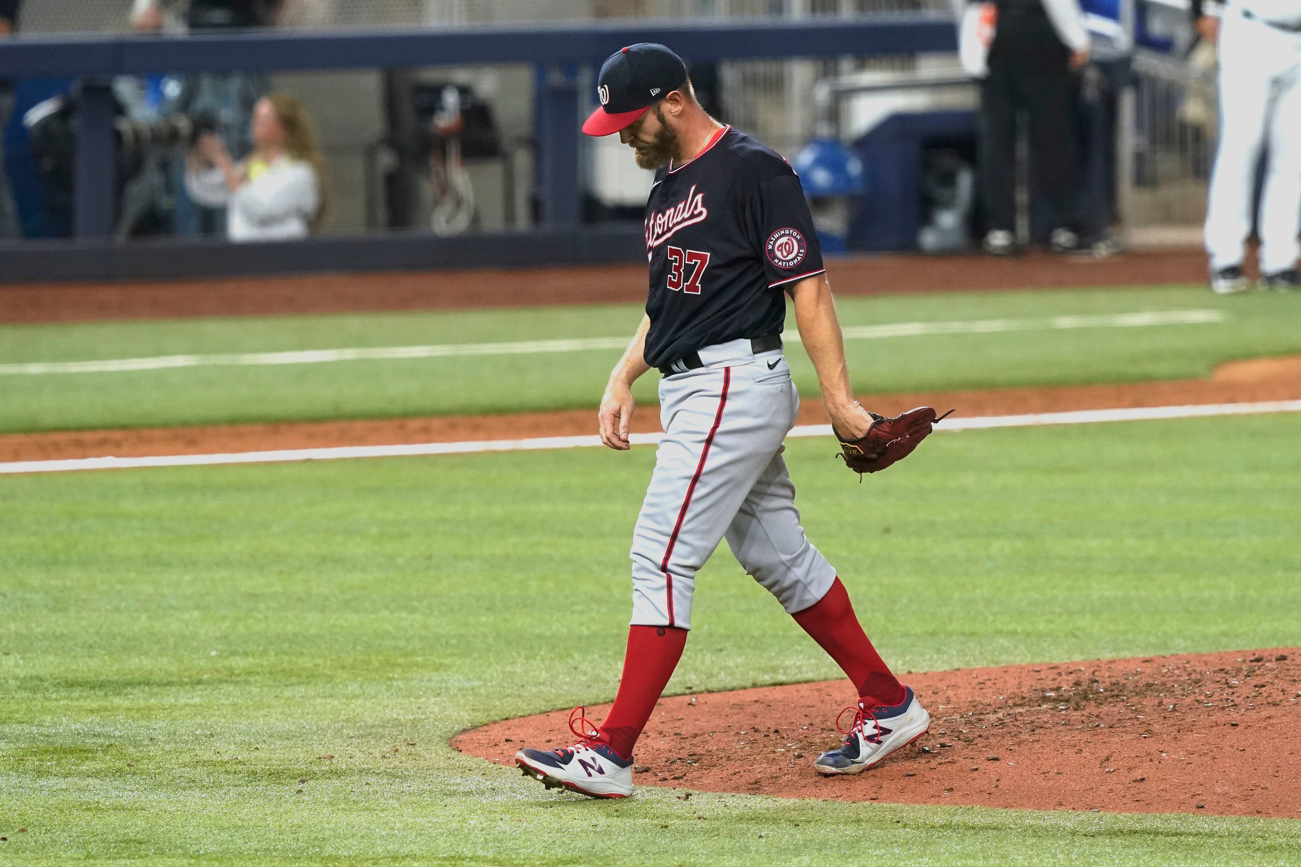 Washington Nationals manager Dave Martinez walks back to the dugout after a  pitching change during a baseball game against the Atlanta Braves early  Saturday, Aug. 14, 2021, in Washington. (AP Photo/Nick Wass