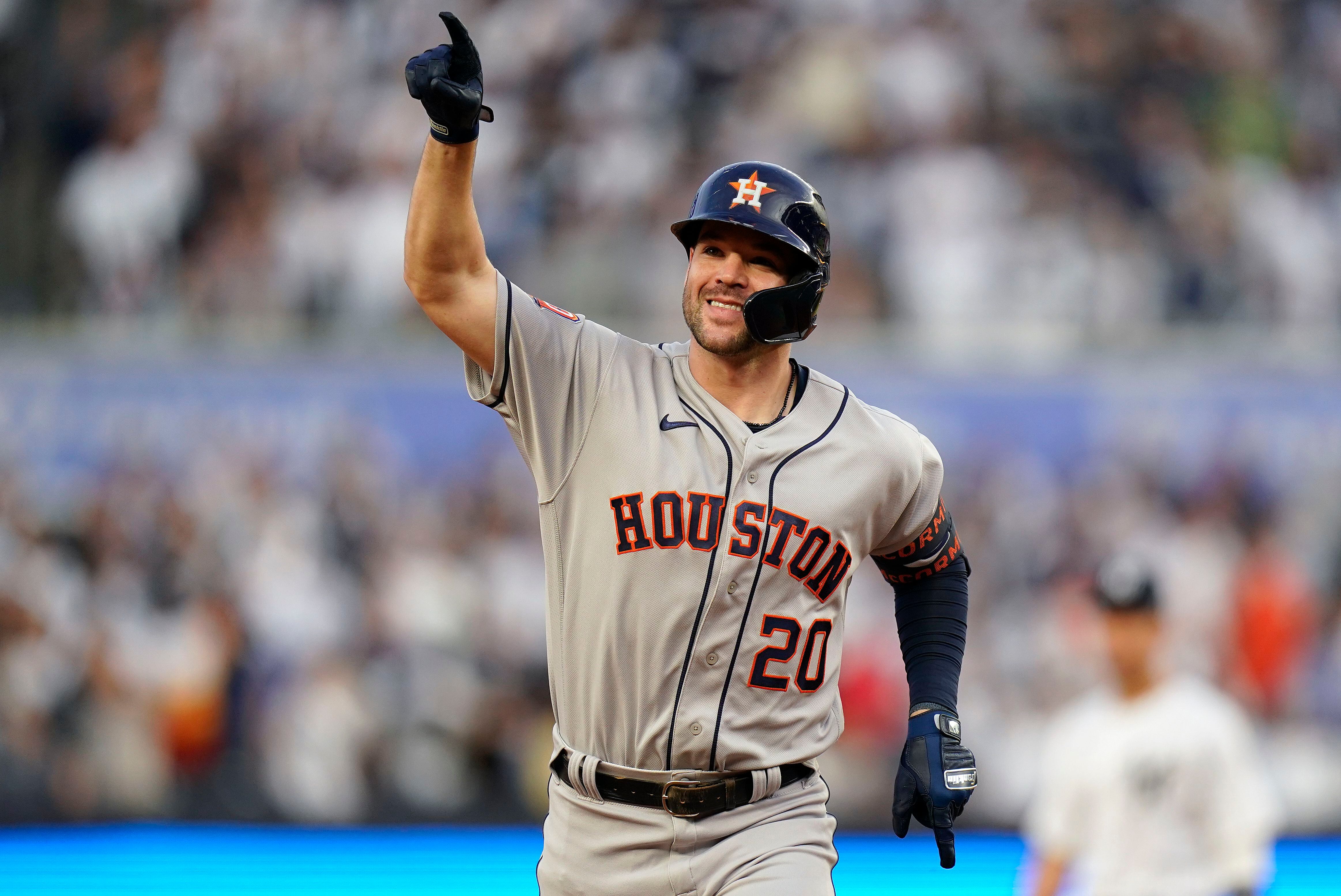 Houston Astros' Alex Bregman, left, points to a camera after hitting a home  run as catcher Christian Vazquez looks to the camera too during the eighth  inning of a baseball game against