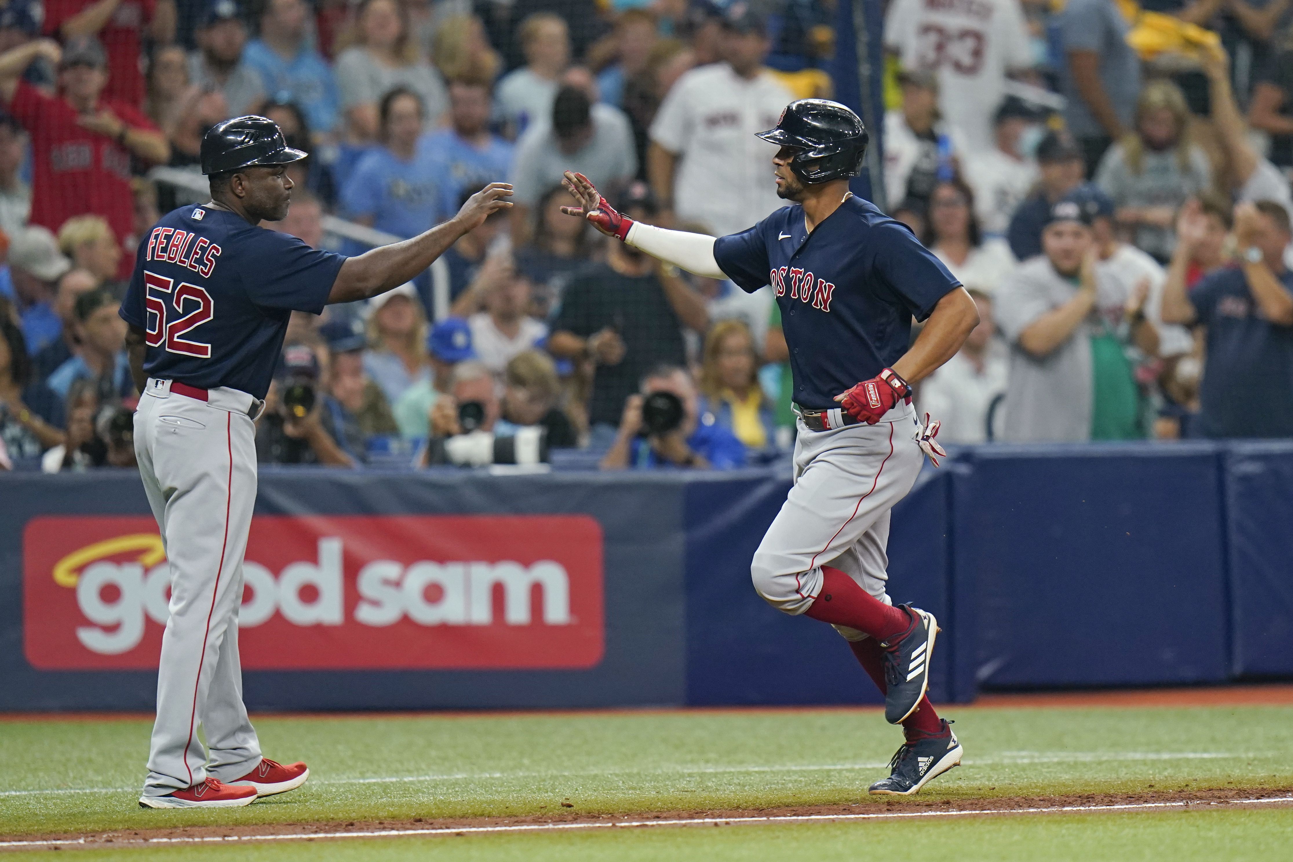 Boston Red Sox's J.D. Martinez, right, is greeted by Xander