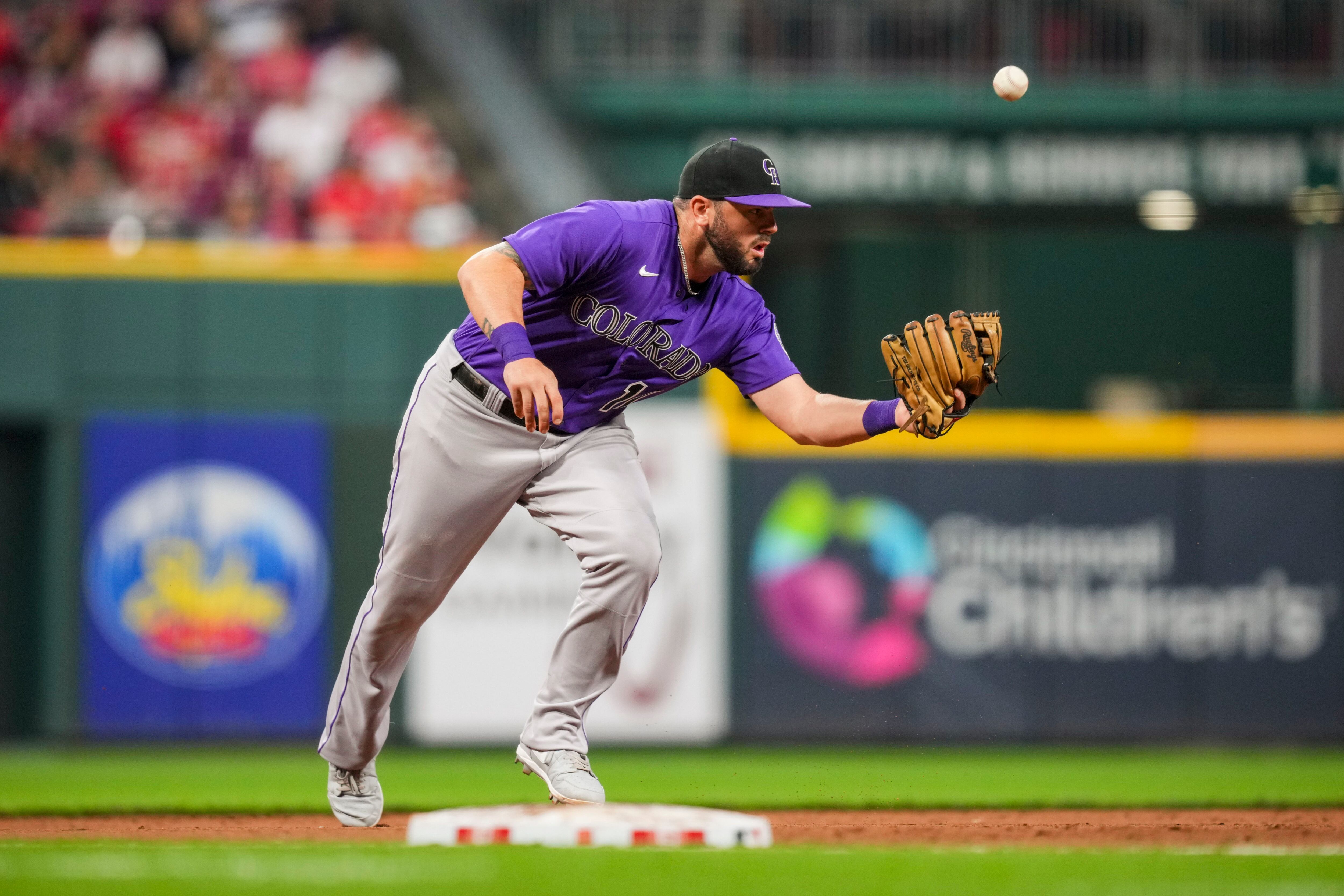 Colorado Rockies' Mike Moustakas warms up before a baseball game