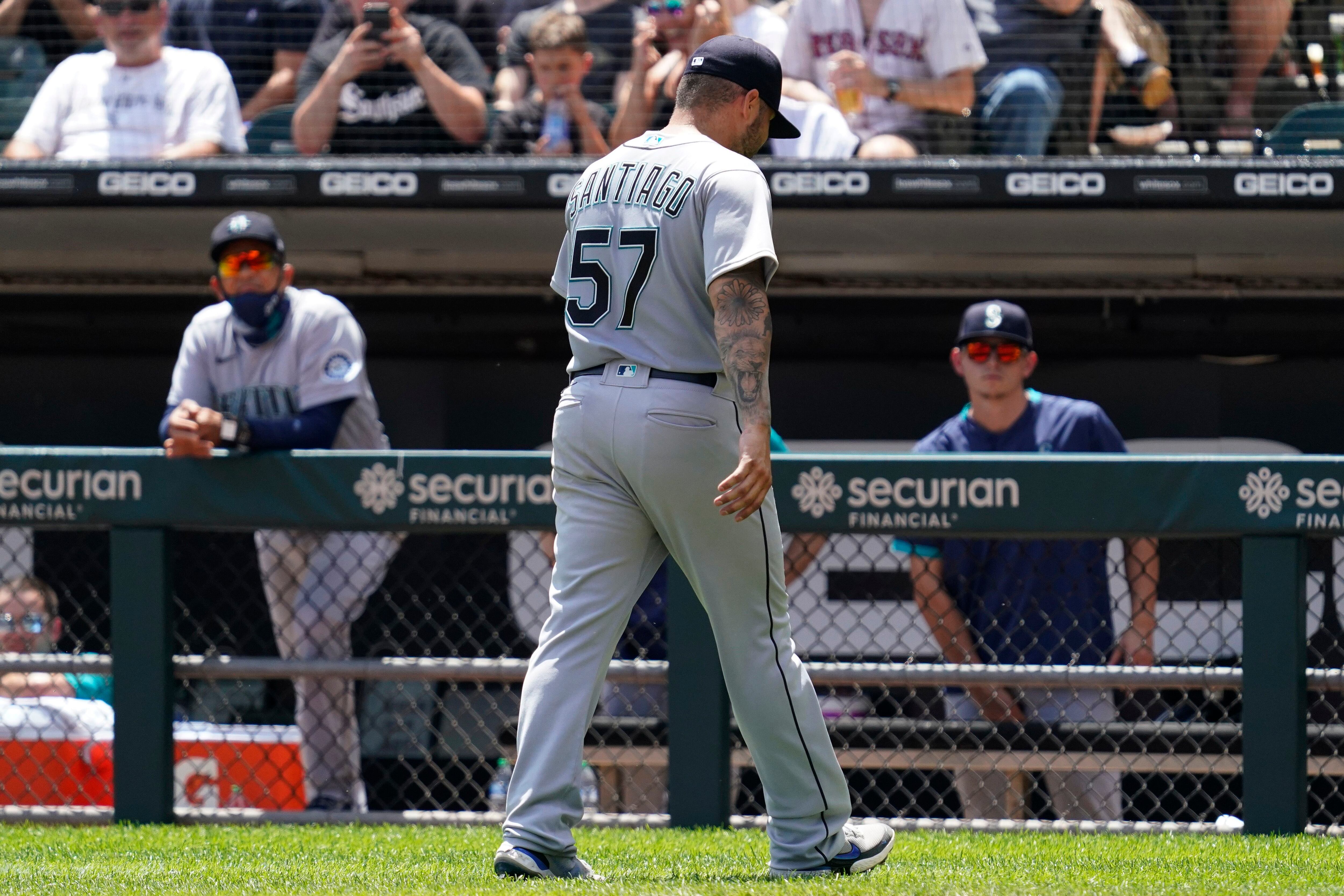 Seattle Mariners relief pitcher Paul Sewald stands between