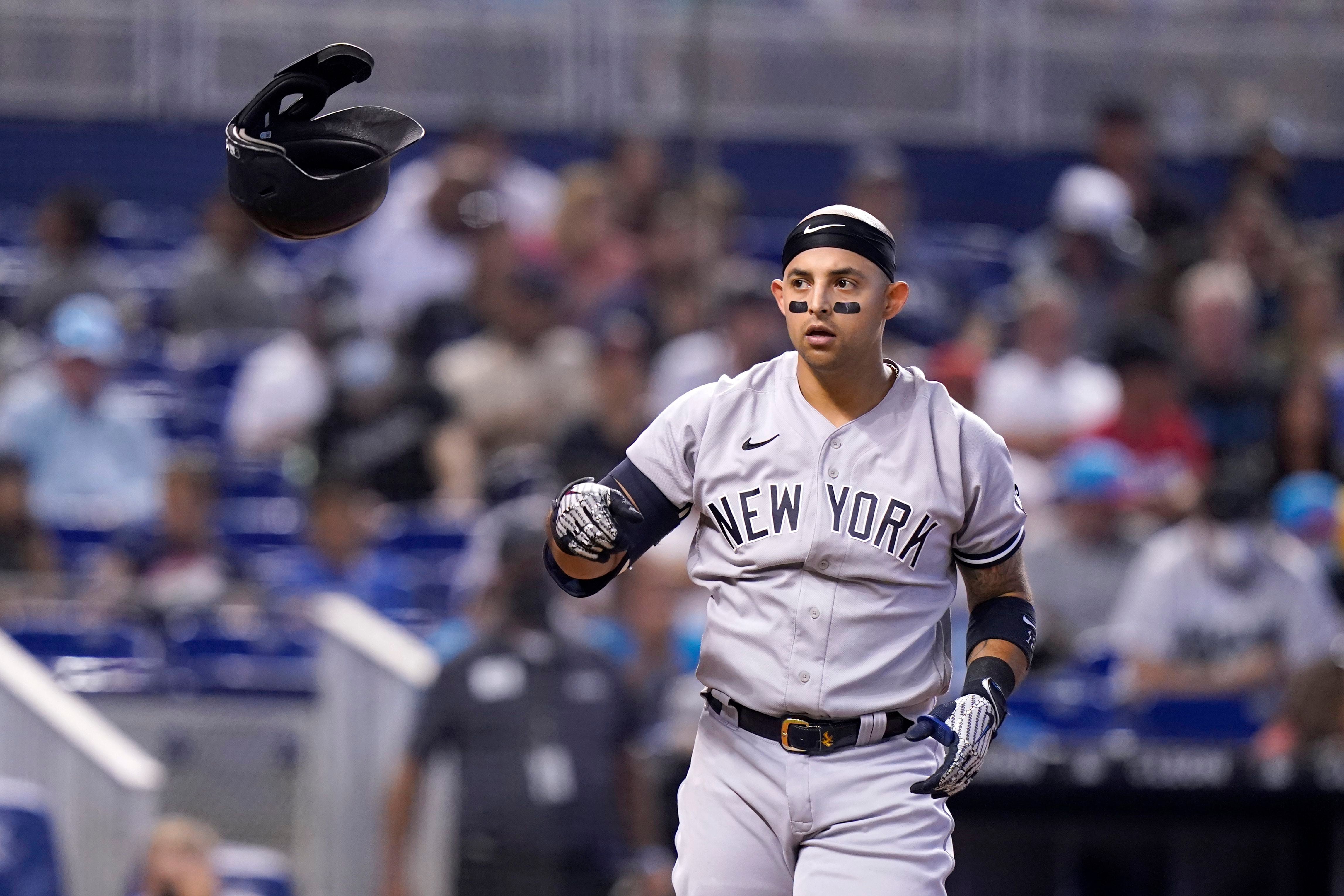 Miami Marlins' Jazz Chisholm loses his helmet as he runs to first base with  a single during the first inning of a baseball game against the New York  Yankees, Sunday, Aug. 1