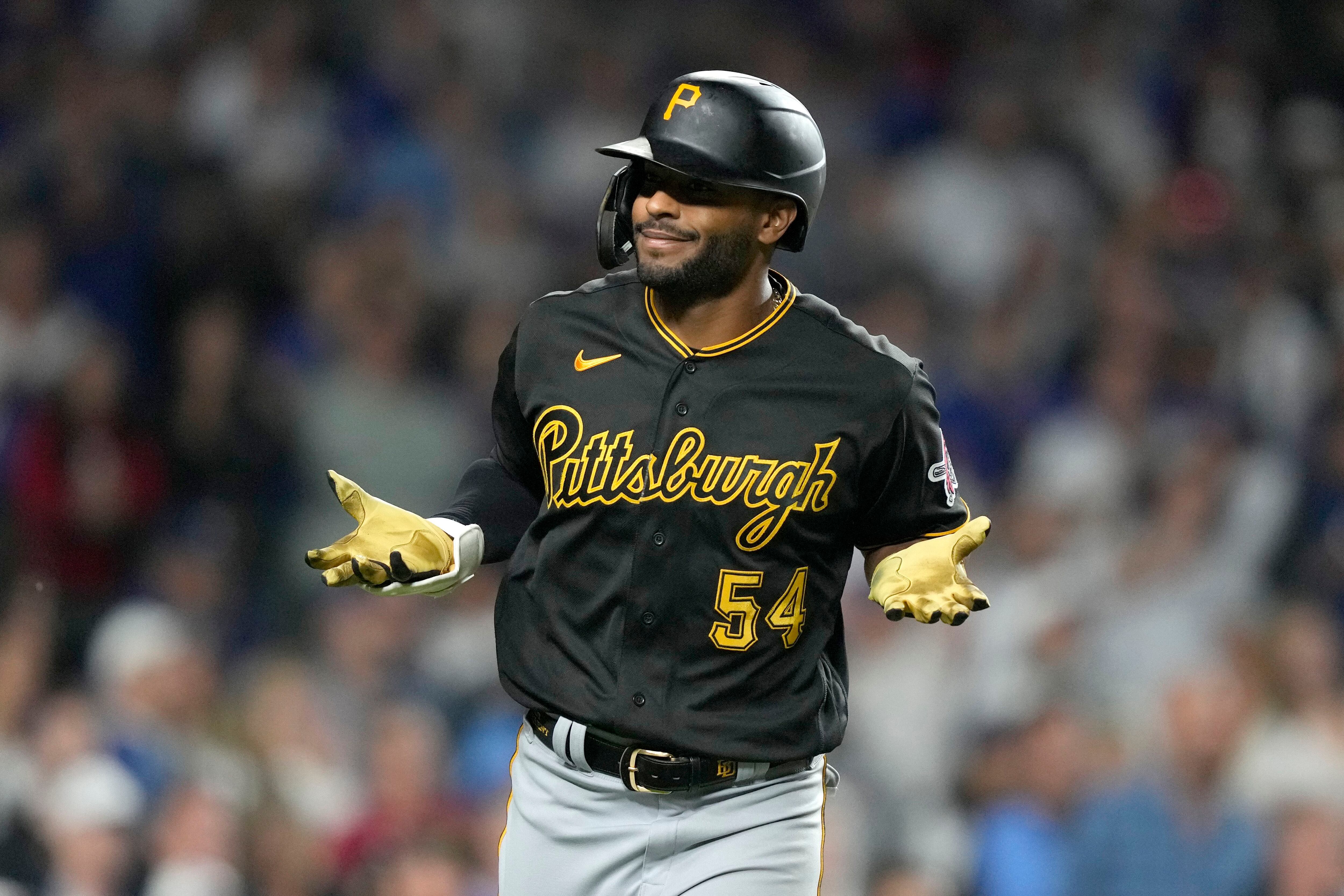 Chicago Cubs' Dansby Swanson watches his home run off Cincinnati