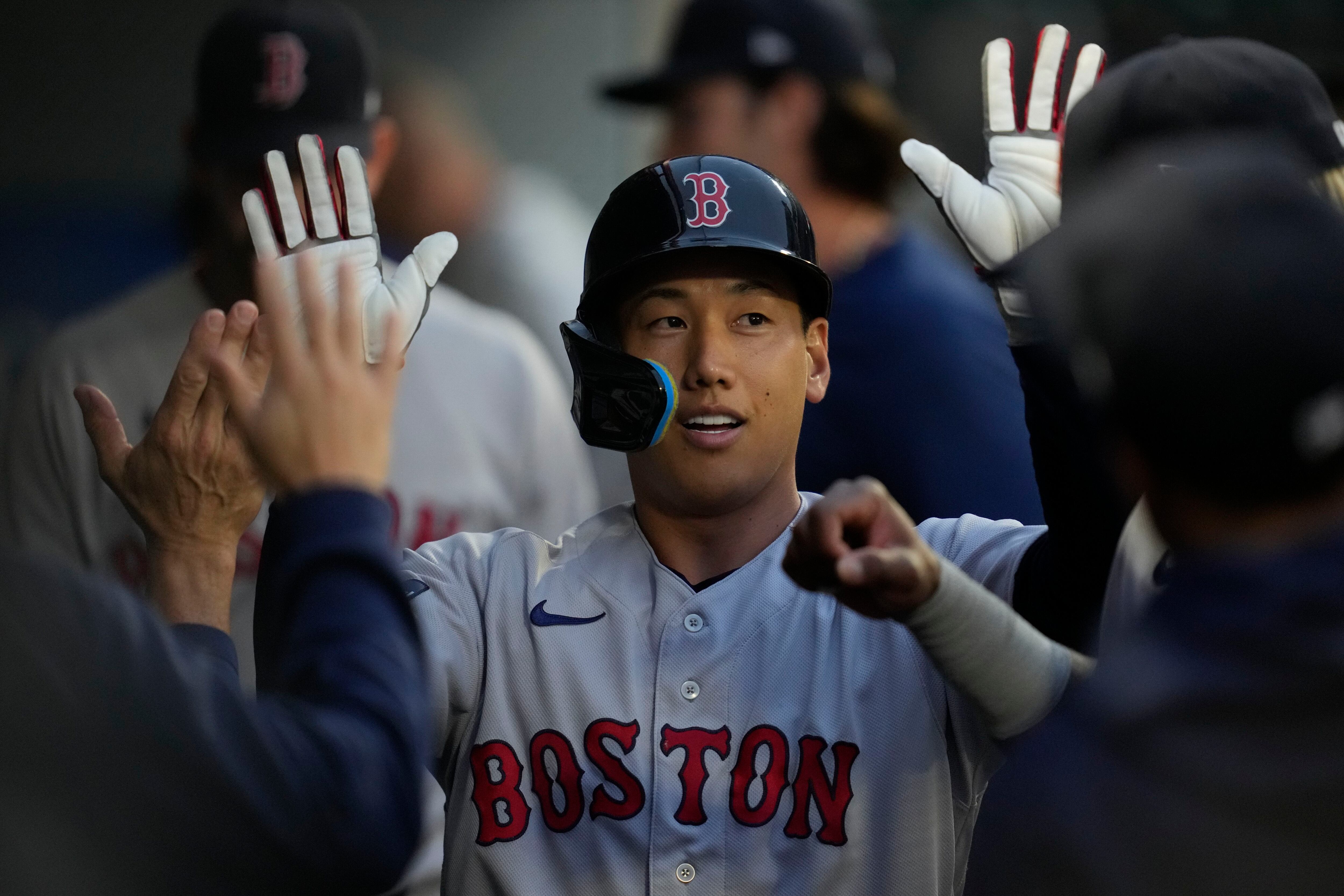 Masataka Yoshida of the Boston Red Sox celebrates in the dugout