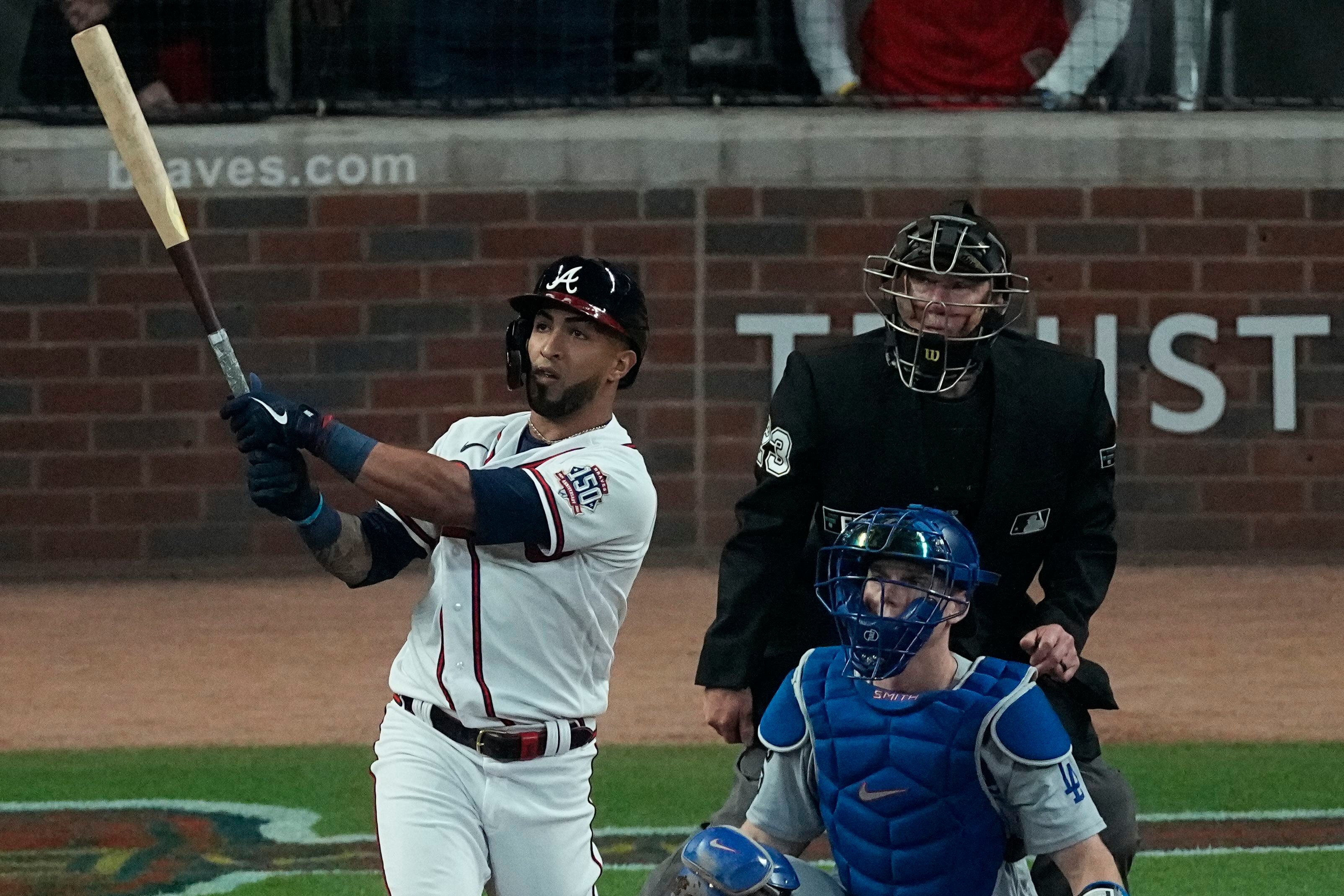 Atlanta Braves' Freddie Freeman (5) turns back with a smile as he heads to  the dugout after hitting a two-run home run in the first inning of a  baseball game against the