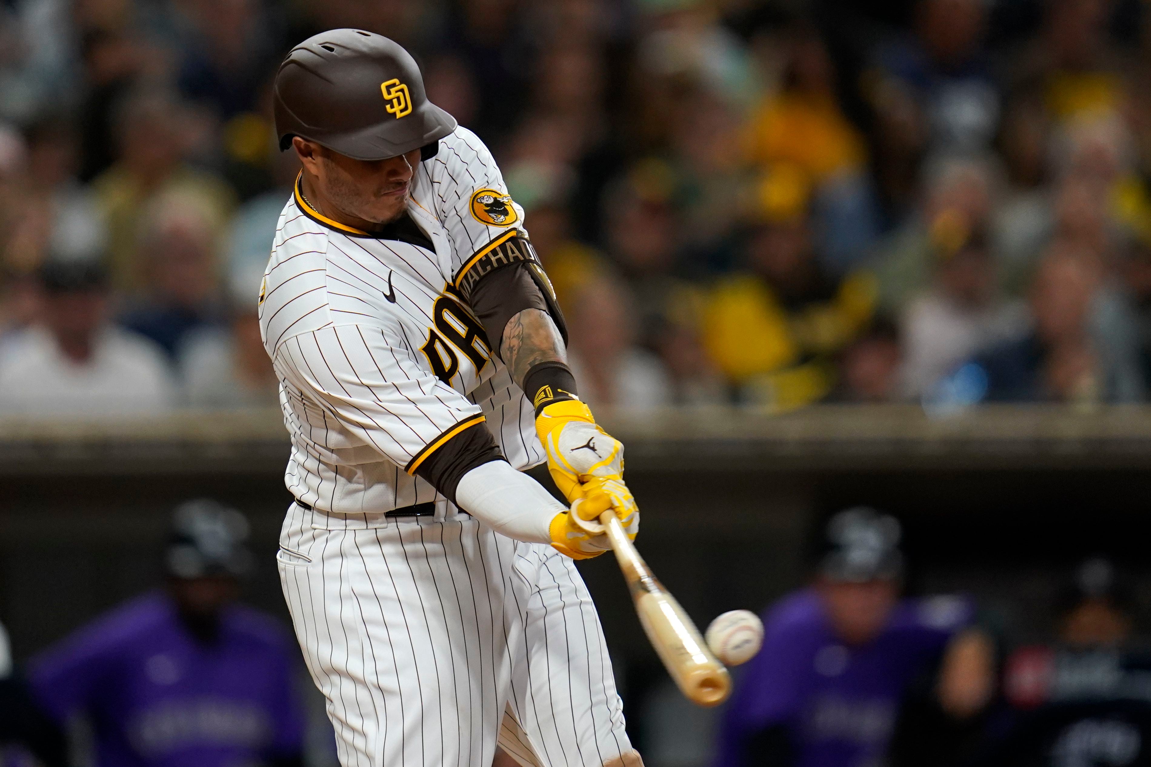 San Diego Padres' Juan Soto, right, heads for the dugout after flying out  to end the baseball game, as Colorado Rockies celebrate a Padres 7-3 win  Thursday, Aug. 4, 2022, in San