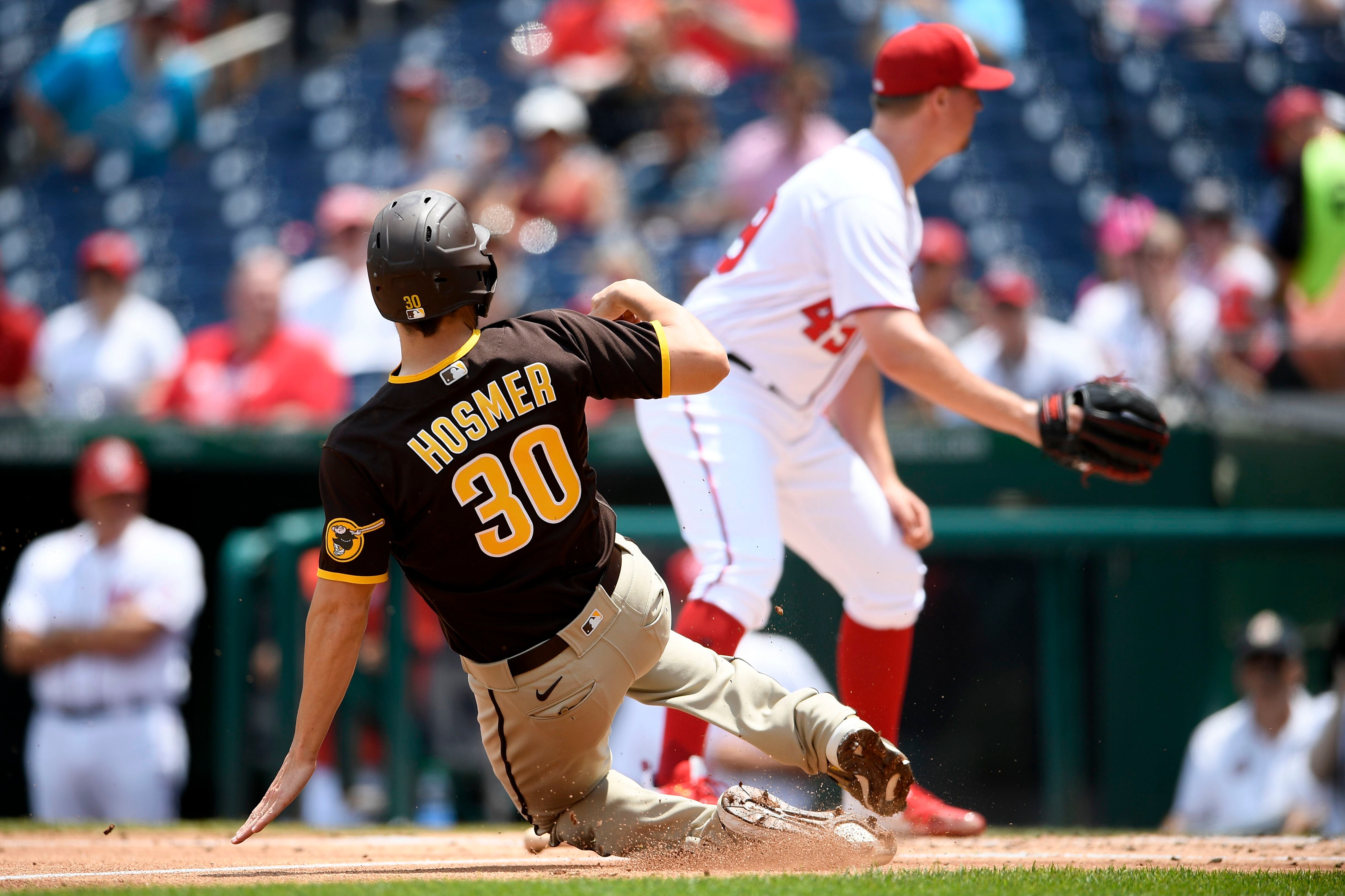 Washington Nationals' Juan Soto, front, stands in the dugout