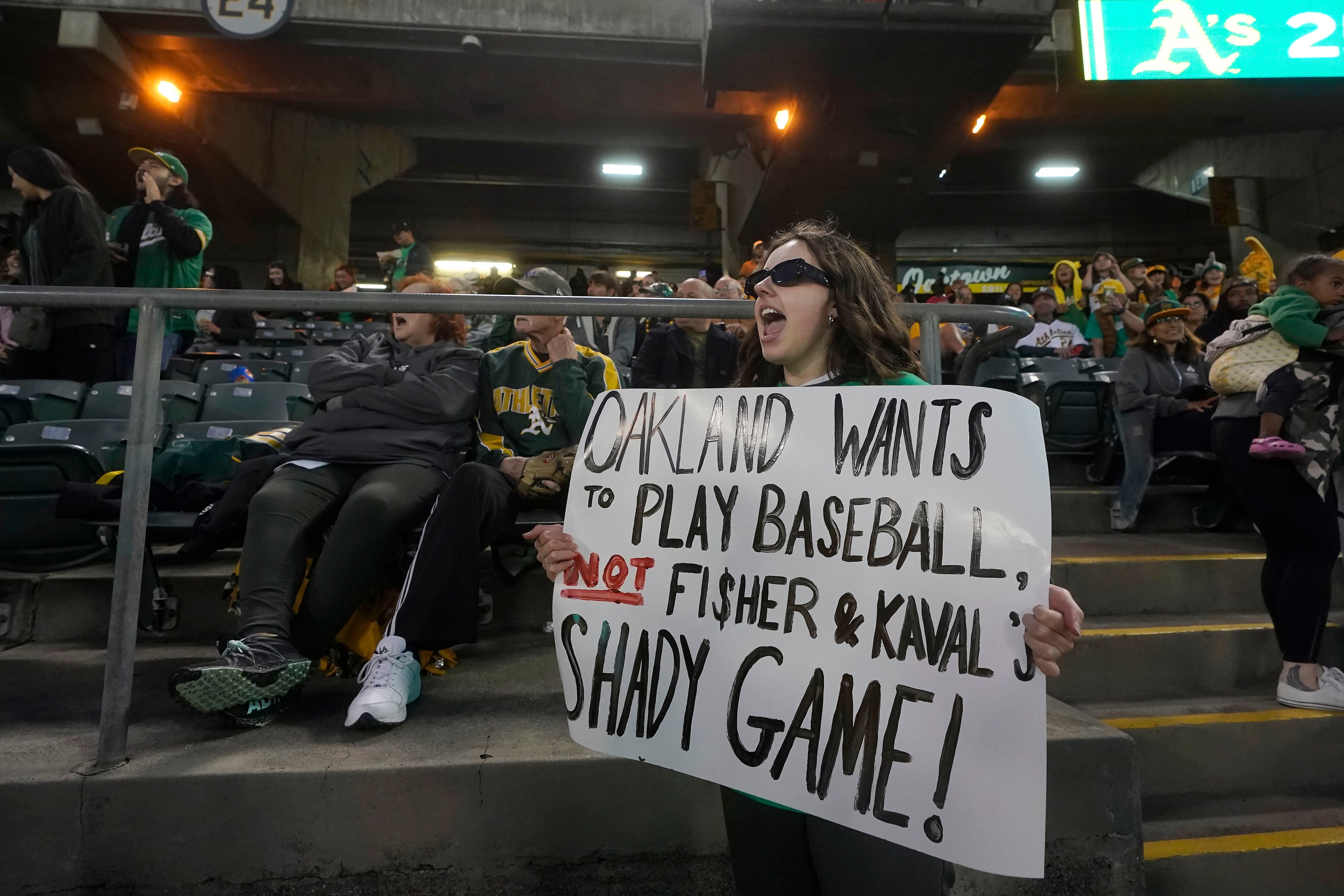 A's met by fans in Oakland with chants of `Sell the team!