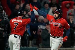 Atlanta Braves left fielder Eddie Rosario can't get a glove on a fly ball  hit by Houston Astros' Aledmys Diaz during the eighth inning in Game 3 of  baseball's World Series between